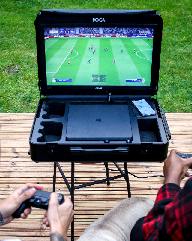 Two people playing a video game on a portable console outdoors.