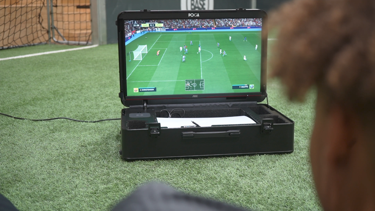 Portable gaming case displaying a soccer game on grass